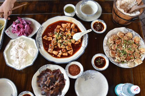 Clarissa Wei feasts on some mapo tofu at a fly restaurant.