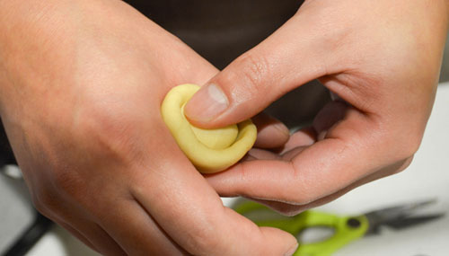 Clarrissa wrapping mooncake dough into a ball